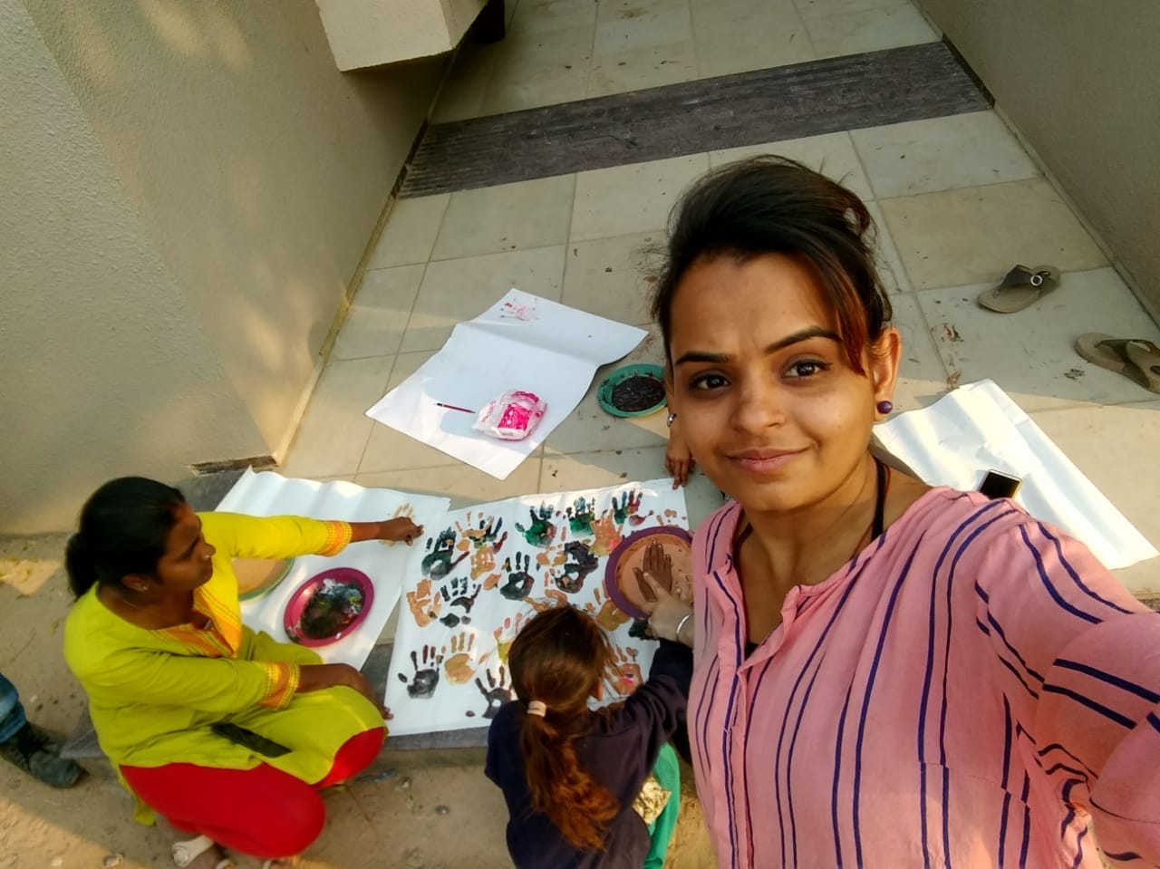Large collection of children's clay creations arranged outdoors