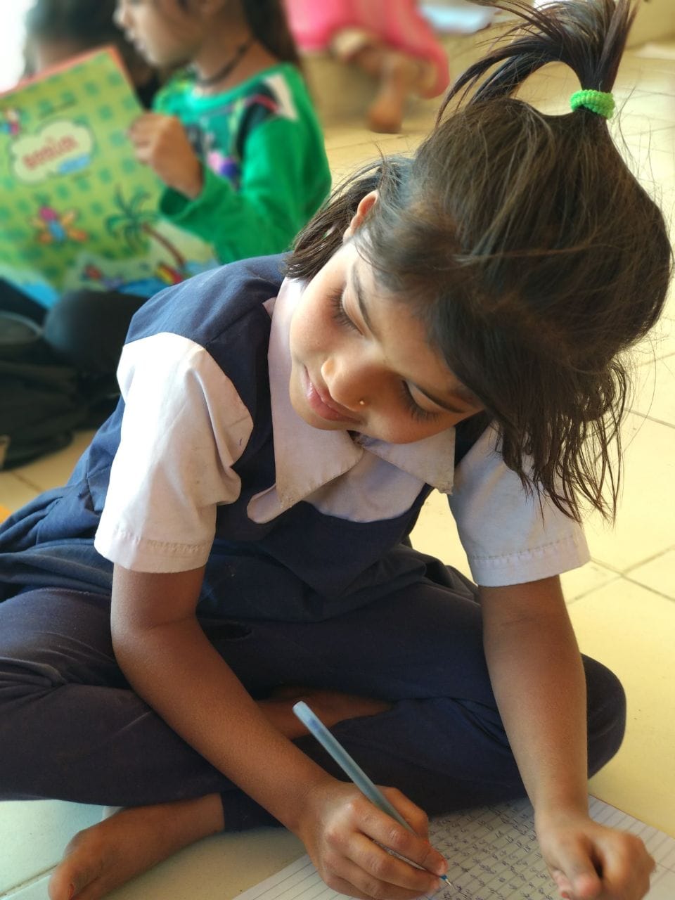 Close-up of same/another girl writing, highly focused