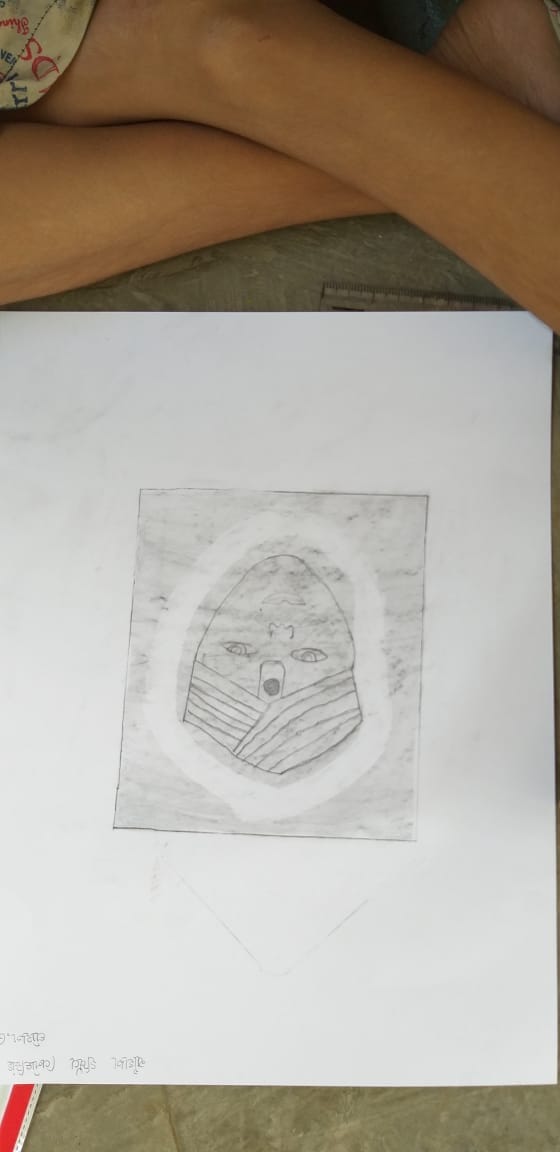 Close-up of a child's artwork: a hand-drawn face/portrait