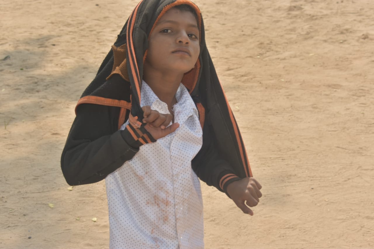 Child playfully posing/acting with hoodie