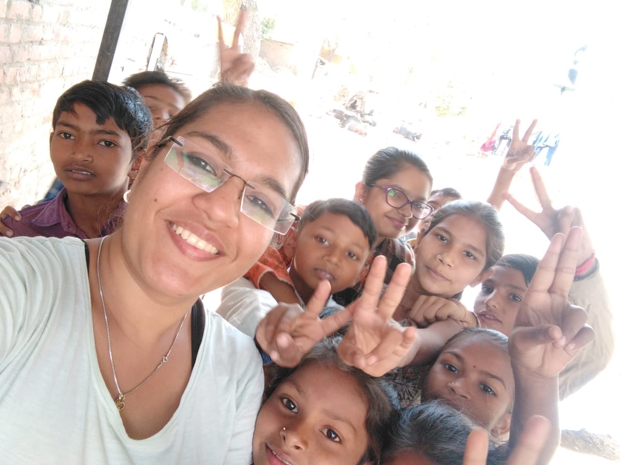 Volunteer + children taking a close selfie