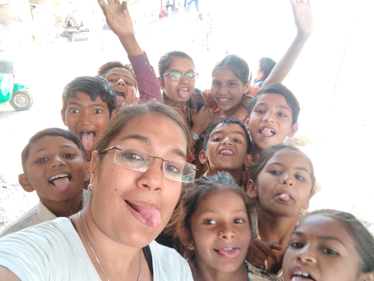 Children and volunteer enthusiastically posing together